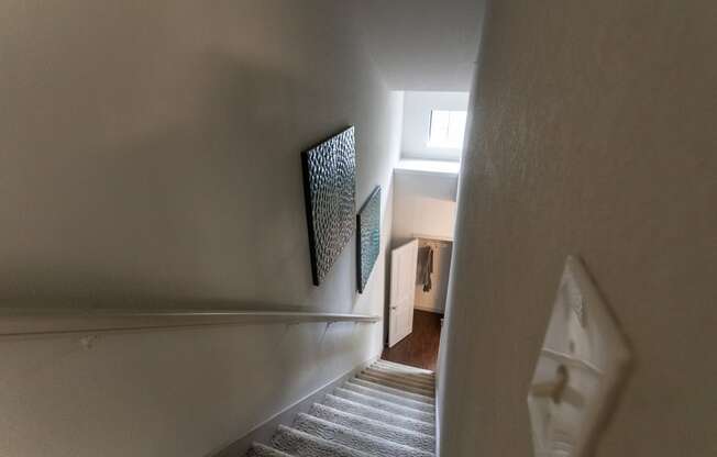 This is a photo of the stairwell from the 3rd floor in the 826 square foot 1 bedroom , 1 bath apartment at The Brownstones Townhome Apartments in Dallas, TX.