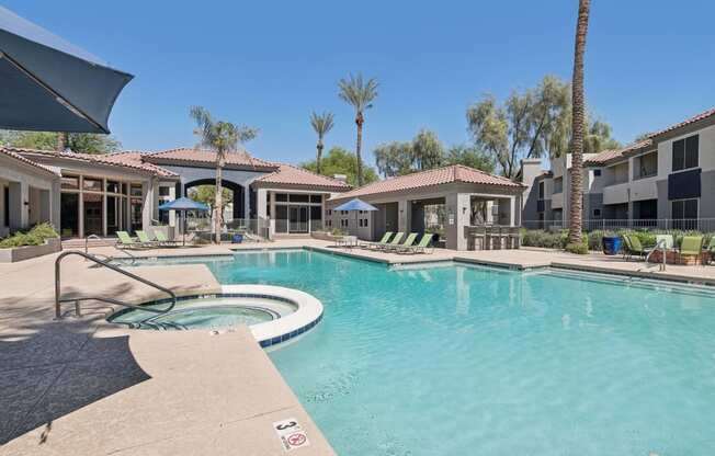 a large swimming pool with apartments in the background