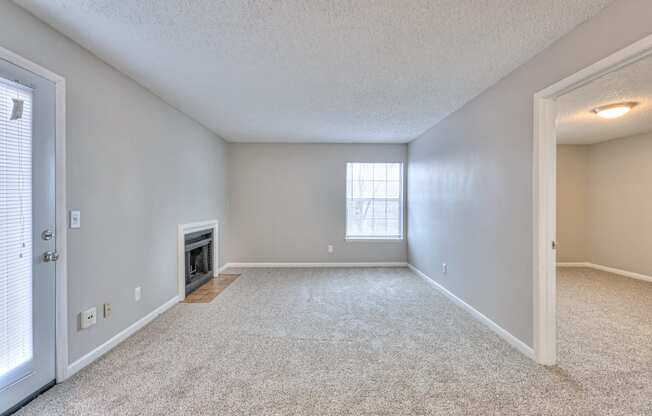 A spacious room with a fireplace and a window at Landmark at Lyncrest Reserve Apartments, Nashville