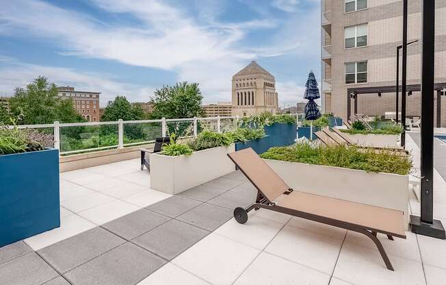 a bench on a roof terrace with a view of the city