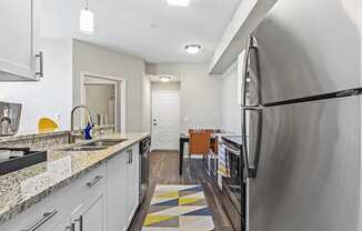 Kitchen with White Cabinets, Stainless Steel Appliances and Hardwood Style Flooring