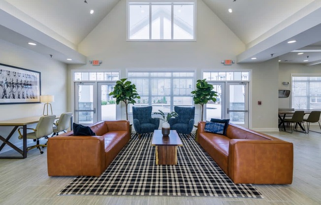 Ashland Farms Resident Clubhouse with Couch Seating, Large Windows, and View of Pool Area