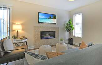 a living room with a fireplace and a tv above it
