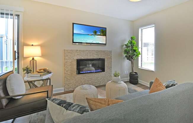 a living room with a fireplace and a tv above it