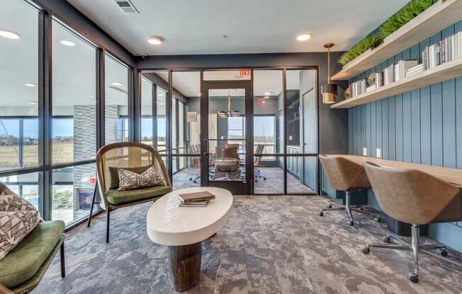 a conference room with a table and chairs and large windows