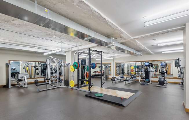 a gym with weights and other exercise equipment in a building