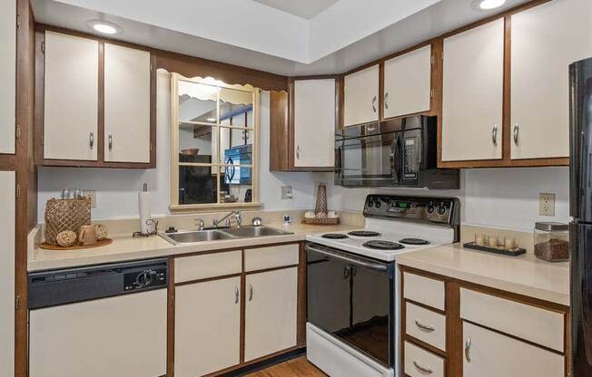 a kitchen with a stove top oven next to a sink