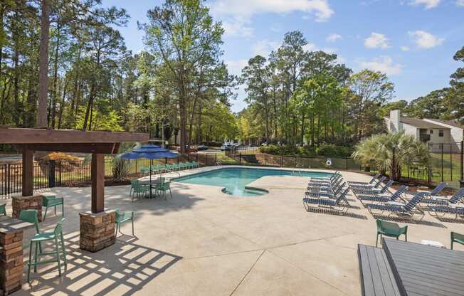 the resort style pool is surrounded by chairs and umbrellas