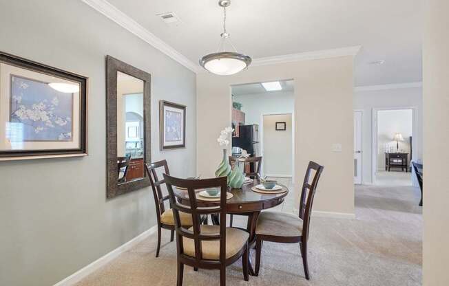 A dining room with a table set for four.