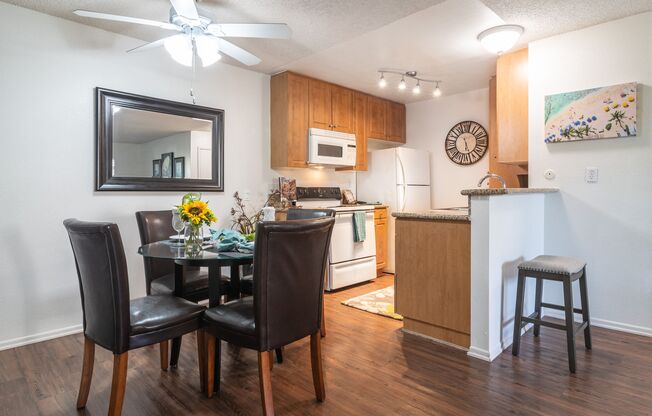 a kitchen and dining room with a table and chairs