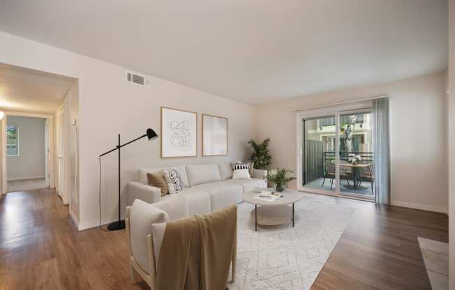 a living room with a white couch and a coffee table at Rush River Apartments, Sacramento