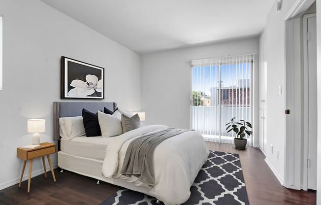 a bedroom with a large bed and a large window