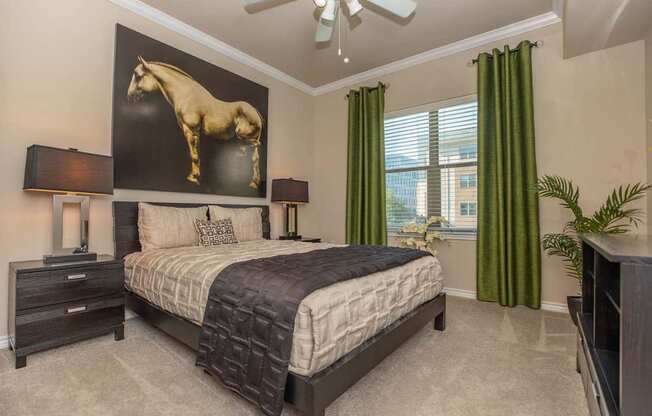 A bedroom with a large bed and a horse picture on the wall.