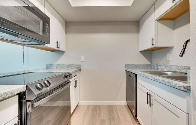 A kitchen with a stove top oven and a microwave.