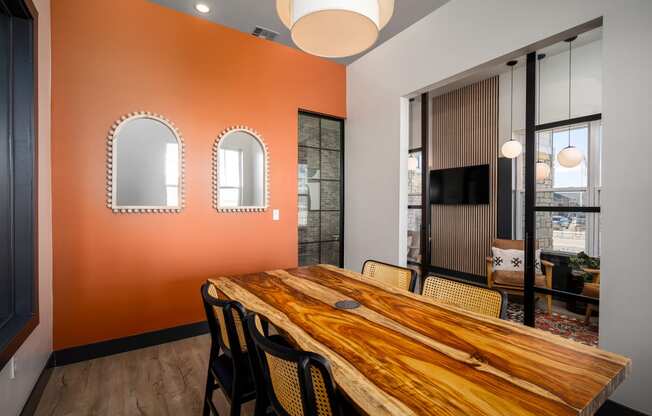 a dining room with a wooden table and chairs