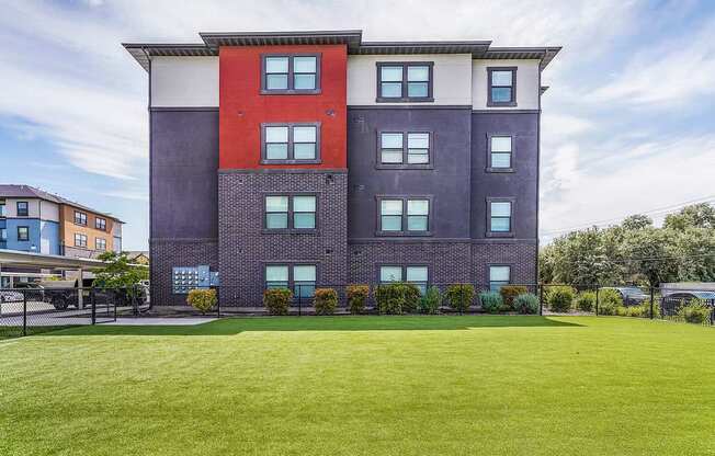 A large multi-story building with a red and purple facade.