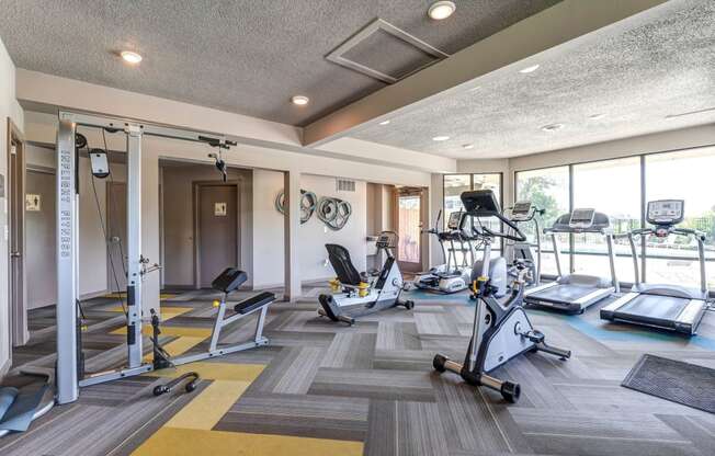 Gym with weights and cardio machines and windows  at Union Heights Apartments, Colorado Springs, CO