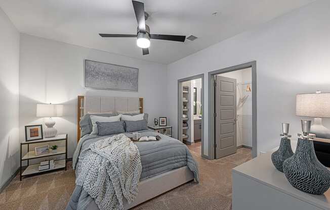 3-Bedroom Apartments in Chattanooga, TN - Populus Waterside - Carpeted Bedroom with Large Bed, Nightstands, Lamps, Private Bathroom, Spacious Closet, and Ceiling Fan.