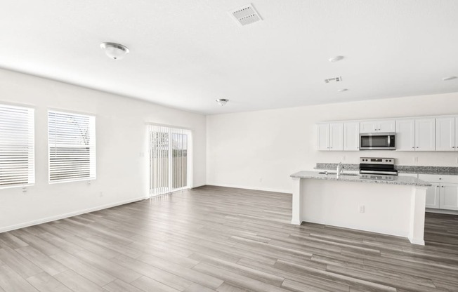 the living room with wood floor and big windows