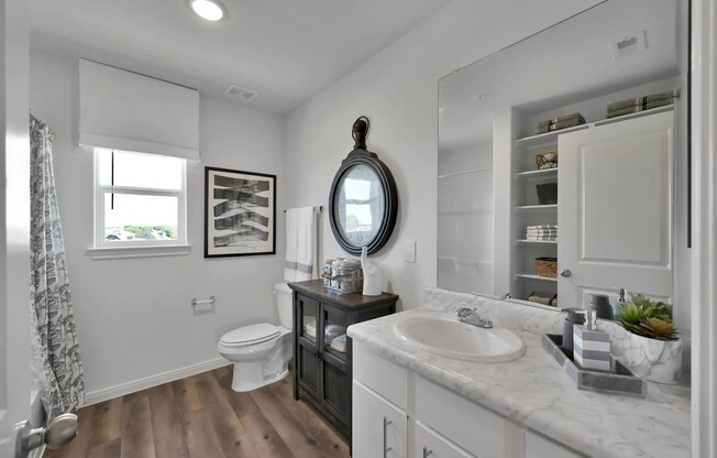 Experience modern living at Esperanza at Wild Orchid. This beautifully designed bathroom features elegant fixtures, ample storage, and a serene ambiance. Elevate your lifestyle in a space that combines comfort and style. Schedule your tour today!