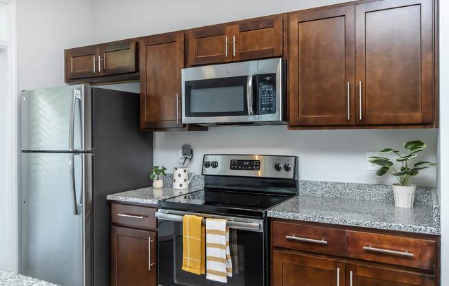 a kitchen with stainless steel appliances and wooden cabinets