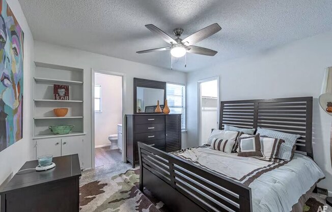 a bedroom with a bed and a ceiling fan