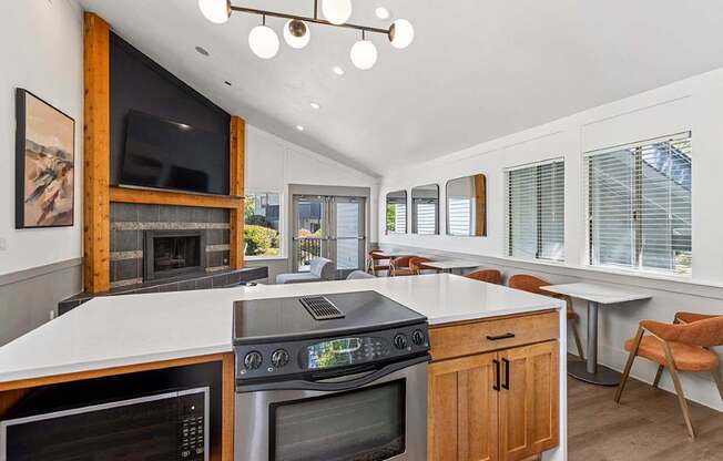 A modern kitchen with a large island and a fireplace.