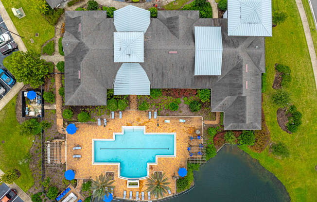 arial view of a swimming pool in the middle of a house