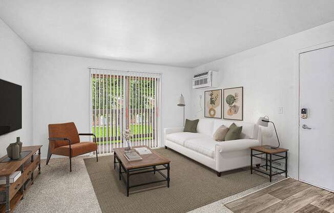 An upgraded living room with a couch and sliding door to a balcony at Waverly Park Apartments in Lansing, MI 48911