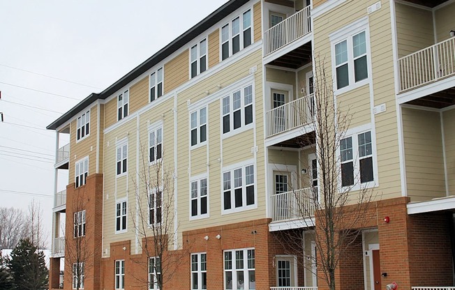 a large apartment building with brick and yellow siding