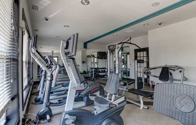 a gym with treadmills and other exercise equipment