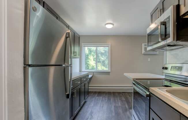 a kitchen with stainless steel appliances and brown cabinets