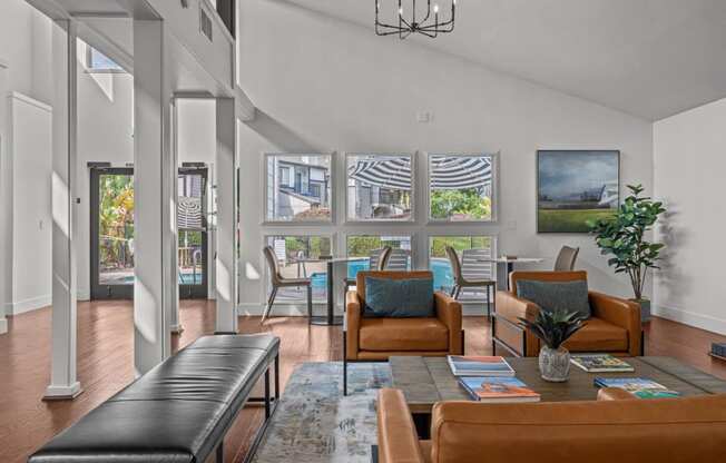 a living room with a table and chairs and a large window