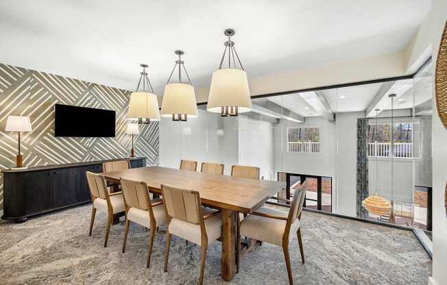 A modern dining room with a wooden table and chairs.
