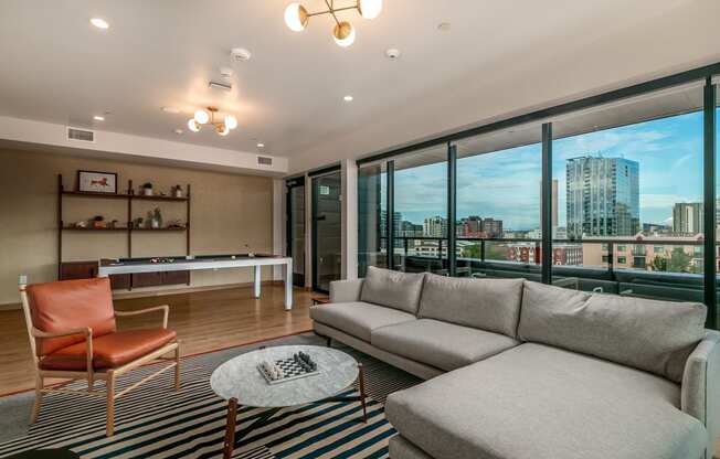 a living room with a couch and a table and a view of the city