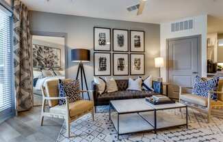 a living room with a couch and chairs and a coffee table