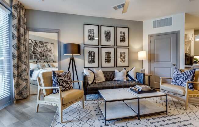 a living room with a couch and chairs and a coffee table