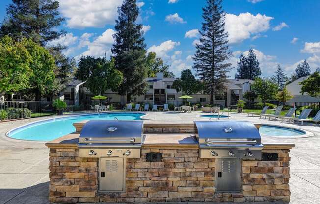 Community Outdoor BBQ and Picnic Area with Grills, Pools and mature landscaping. at Monte Bello Apartments, Sacramento ,95826