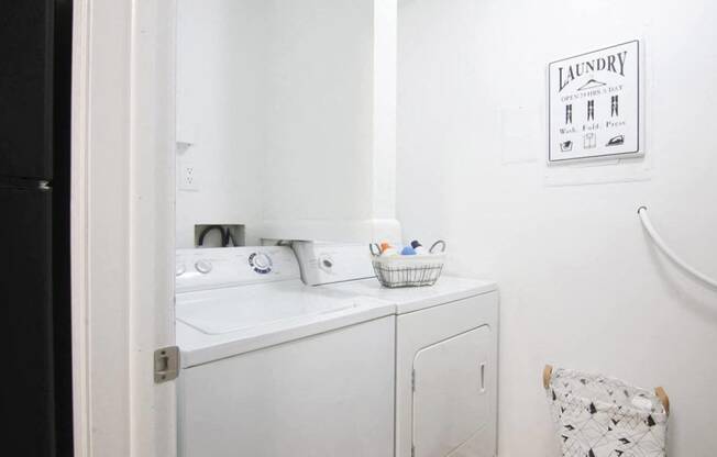 a small laundry room with a sink and a washing machine