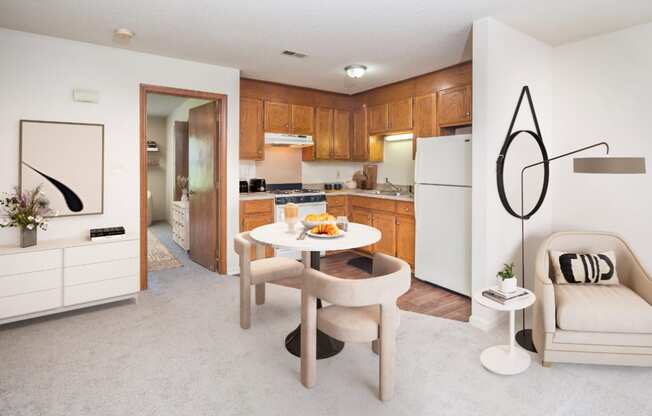 a kitchen and dining room with a table and chairs