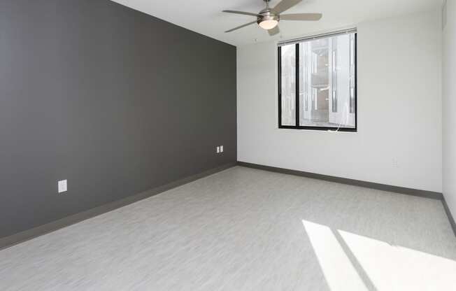 Bright, vacant bedroom with neutral walls and carpet flooring.