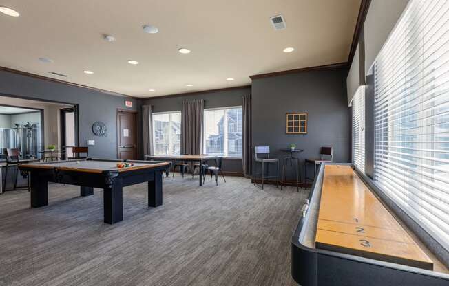 a game room with a pool table and a shuffleboard