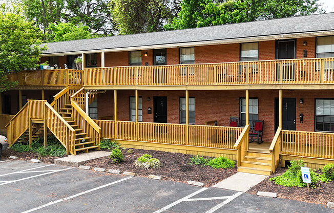 A building with a red brick exterior and a wooden balcony.