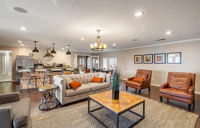 A living room with a brown leather couch and a wooden coffee table.