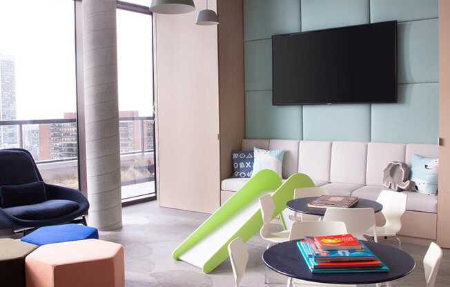 a living room with a table and chairs and a television at The Lively, Jersey City, NJ 07302