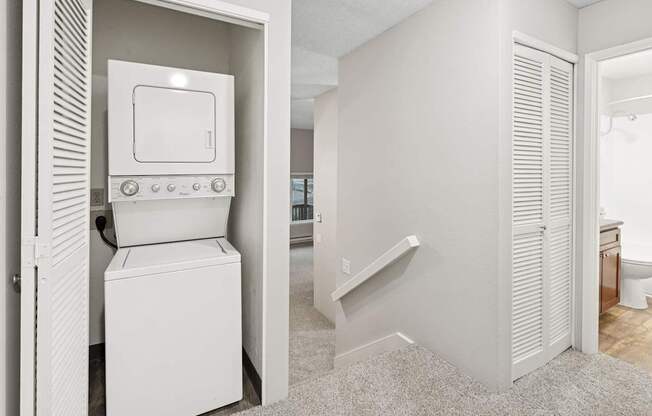 A white washing machine and dryer in a laundry room.