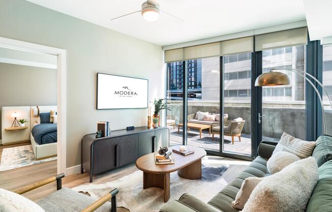 An airy living room at Modera McGavock, opening to a private terrace and city views, with Nashville’s dining and entertainment close at hand.