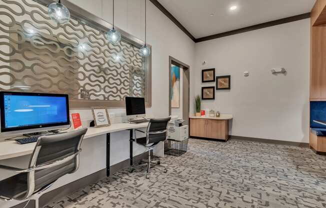 a conference room with a desktop computer on a desk