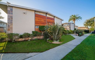 A modern house with a red and orange garage door.