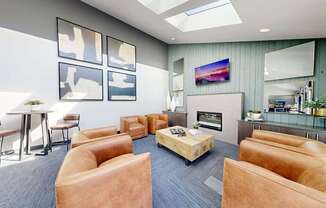 A modern living room with a skylight, a flat screen TV, and a coffee table.